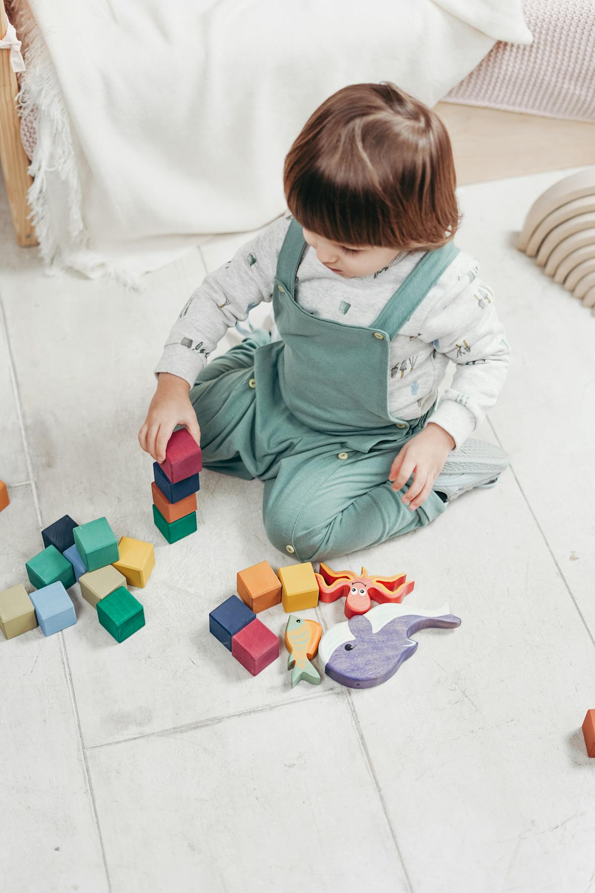 Child stacking blocks during an occupational therapy session